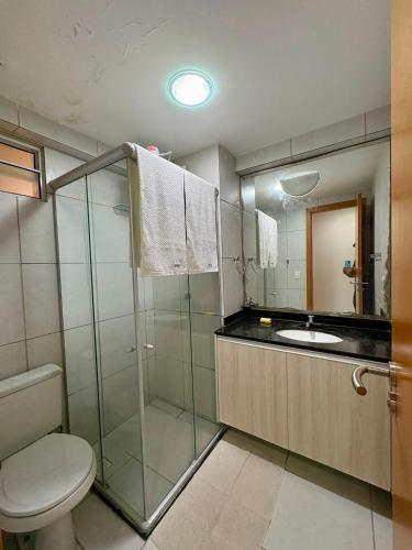 a bathroom with a shower and a toilet and a sink at West Flat - BarretoStays 03 in Mossoró