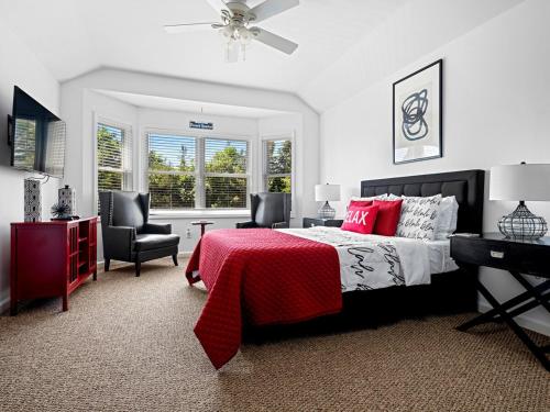 a bedroom with a bed and a desk and chairs at Beautiful 6-Bedroom Escape Featuring a Private Pool in Hampton Bays
