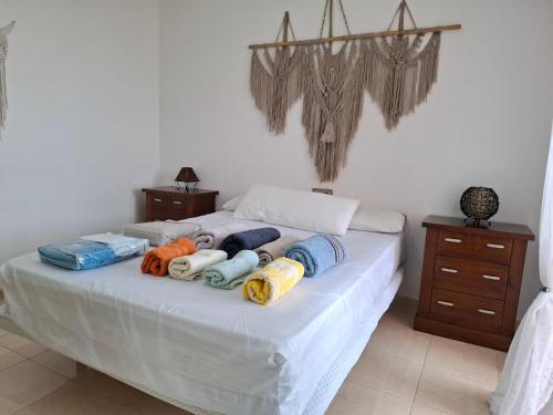 a bed with a bunch of pillows on it at Apartamento Playaluna in Almería