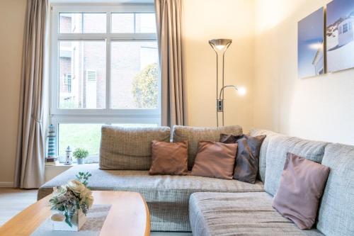 a living room with a couch and a window at Haus Roland, Wohnung 19 in Zinnowitz