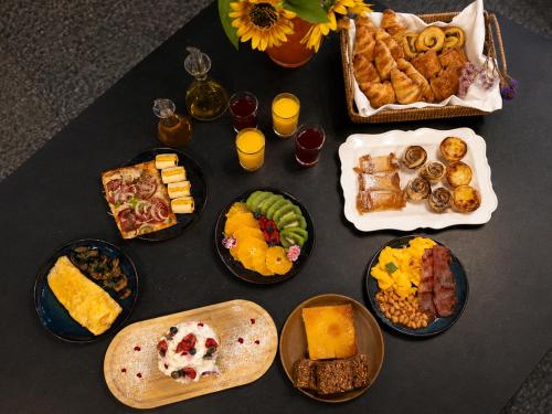 a table with a bunch of different types of food at The Editory House Ribeira Porto Hotel in Porto