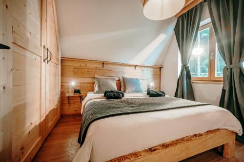 a bedroom with a large bed and a window at Duh šume in Kupjak
