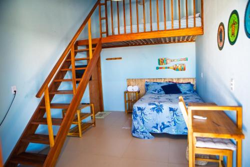 a bedroom with a bunk bed and a staircase at Loft Azul - Pousada Vila Dondom in Luis Correia
