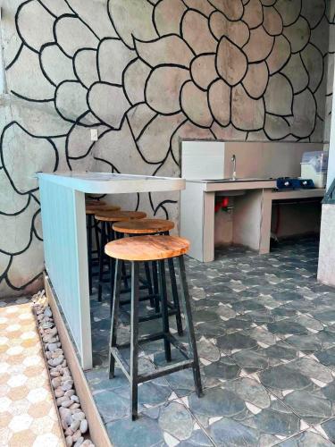 a bar with stools and a counter in a kitchen at Leonaldo's Farm and Staycation in Kinalaglagan