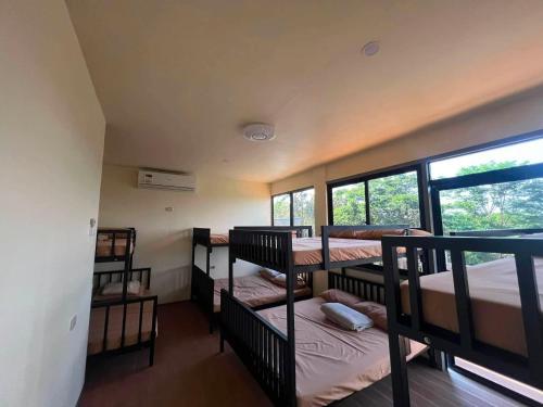 a dorm room with four bunk beds in it at Leonaldo's Farm and Staycation in Kinalaglagan