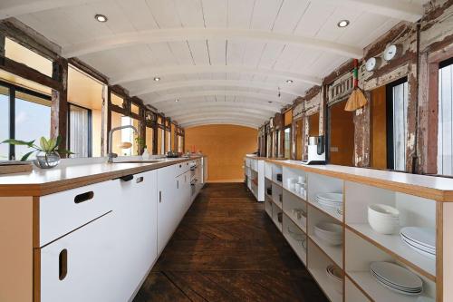 an old train car with white counters and sinks at El Ray by Bloom Stays in Dungeness