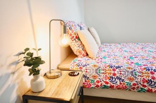 a bedroom with a bed and a table with a plant at Chambre d'hôtes Château Austerlitz in Libourne