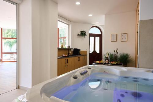 a large bath tub in a room with at Hotel Wellness Radnice Dobrovice in Dobrovice