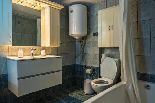 a bathroom with a toilet and a sink at La Nonna in Komotini