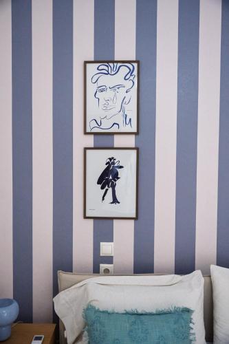 a bedroom with blue and white stripes on the wall at La Nonna in Komotini