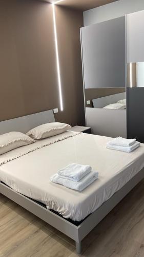a bedroom with a bed with two towels on it at Solea Home in Termoli