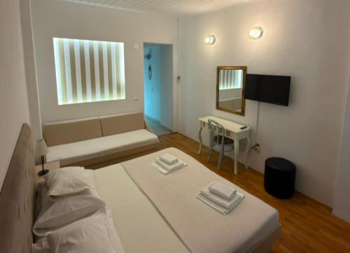 a bedroom with a bed and a table and a mirror at Riva Brela in Brela