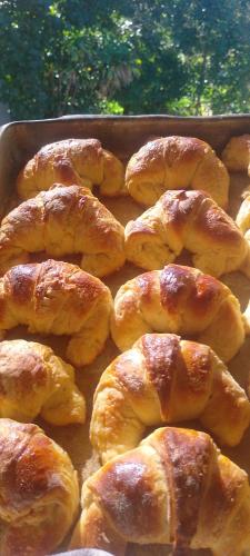 a pan filled with croissants sitting on a table at FOLHA HOUSE Experience in Paraty