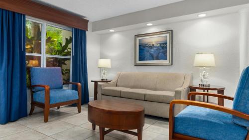 a living room with a couch and two chairs at Club Wyndham Sea Gardens in Pompano Beach