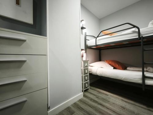a bedroom with two bunk beds and a closet at AC Apartaments Centre in Pas de la Casa