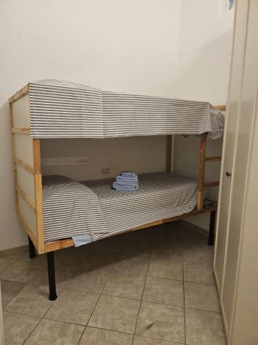 a wooden shelf in a room with a bed at Garibaldi 39 in Loano