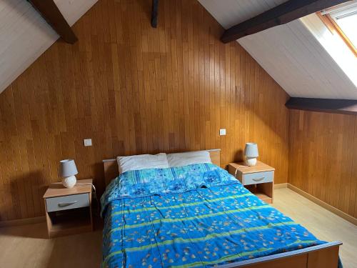 a bedroom with a blue bed with two night stands at Douceur Meyralaise in Meyrals