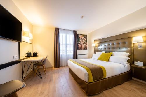 a hotel room with a large bed and a desk at Best Western Hotel du Chateau Maisons Laffitte in Maisons-Laffitte