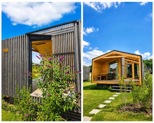 a small house with a large window in a garden at 309 Stylisches Tiny House für Familien in Bleckede
