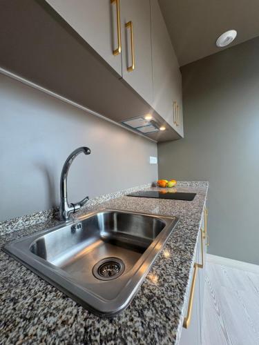 a kitchen counter with a stainless steel sink at Escolapios Centro in Monforte de Lemos