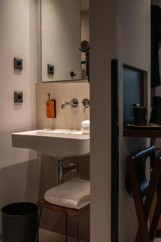 a bathroom with a sink and a mirror at gambino hotel GOETHE26 in Munich