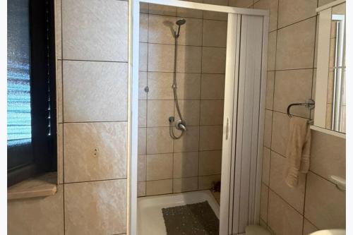a bathroom with a shower with a glass door at Panoramic Sea view Deluxe Apartment in Joppolo in Ioppolo