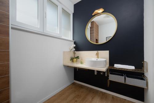 a bathroom with a sink and a mirror at Vila Matak in Ražanac