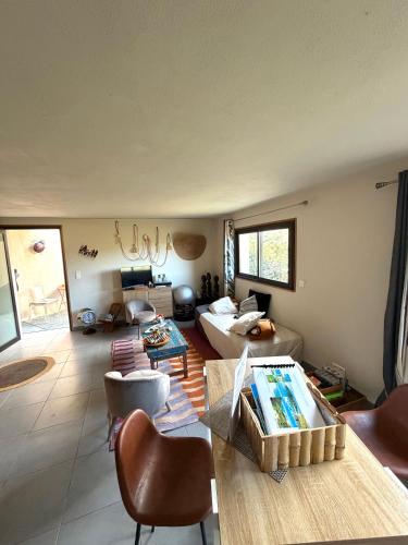 a living room with a couch and a table at T2 entre Mer et Montagnes in Porto-Vecchio