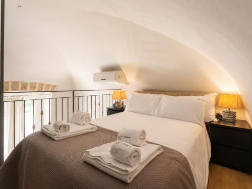 a bedroom with a bed with towels on it at Wanderlust Experience Fronte Porto in Bari
