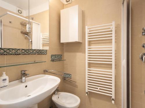 a bathroom with a sink and a toilet and a mirror at Wanderlust Experience Fronte Porto in Bari