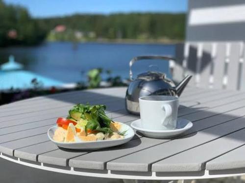 a table with a plate of food and a cup of coffee at Hotel Lahnajärvi in Lahnajärvenkylä