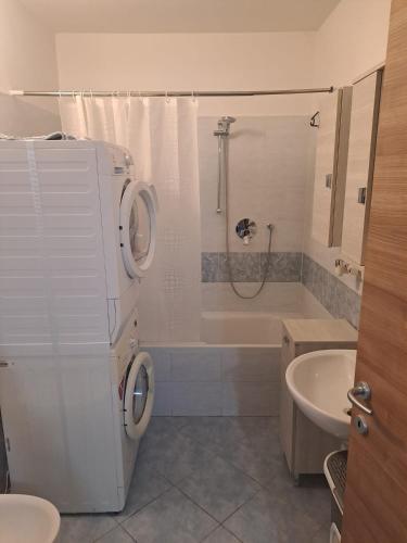a bathroom with a toilet and a sink and a shower at Casa Levante in Brugnato