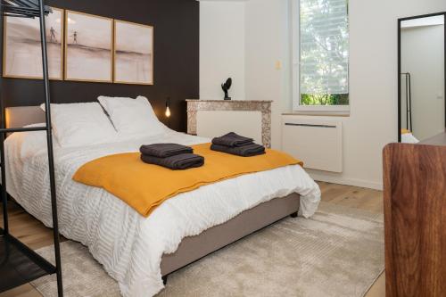 a bedroom with a bed with two towels on it at La Suite Cacao in Saint-Rambert-dʼAlbon