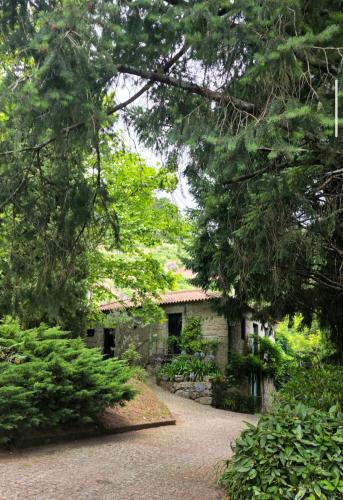 a stone house in the middle of a garden at Casa das Feitorias Douro Valley in Baião