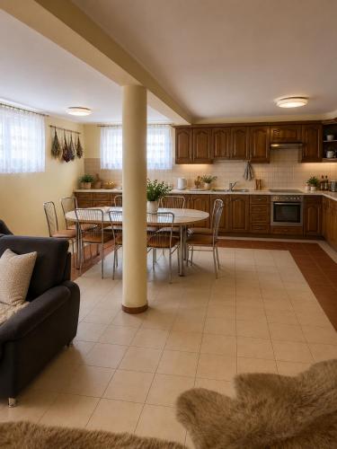 a kitchen and dining room with a table and chairs at Magiczny Dom nad Bugiem in Pętkowo Wielkie