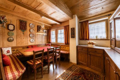 a dining room with a table and chairs at Cesa Linda by AMA Val di Fassa in Campitello di Fassa