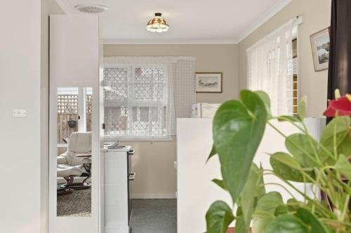 a kitchen with a door open to a living room at Kings Corner in Sandy Bay