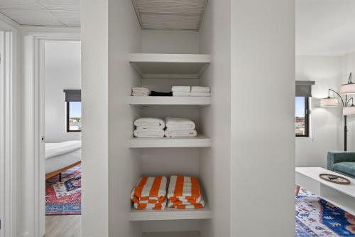 a room with white walls and shelves with towels at Astral Desert Retreats in Mesa