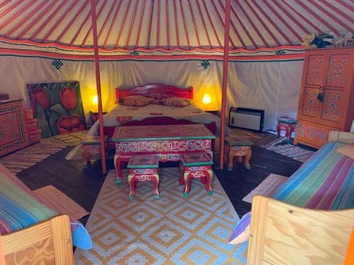 a bedroom with a bed in a tent at Bastide de montchamp in Malataverne