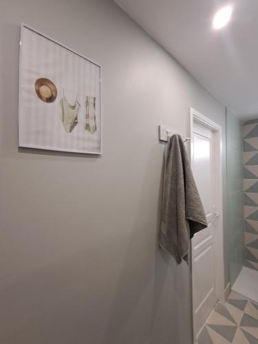 a bathroom with a towel hanging on a wall at Chemin du vieux Puits in Surgères