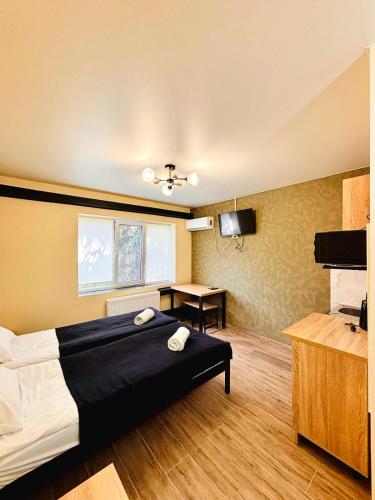 a hotel room with a bed and a desk at Shpola Central Hotel in Shpola
