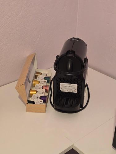 a black toaster sitting on a table next to a box at Quiet Room in Florina