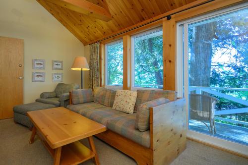 a living room with a couch and a table at 148 Divot Simcoe Cottage private Beach, Kayak in Georgina