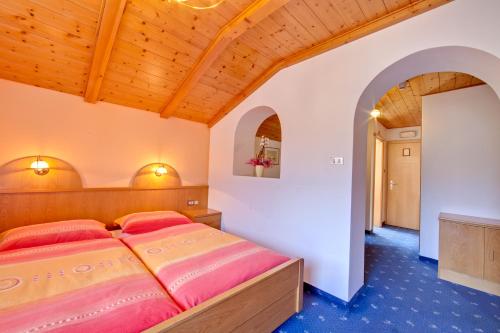 a bedroom with a bed with red pillows at Parkhotel Plauserhof in Plaus