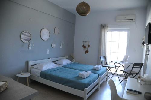 a bedroom with a bed and a table and chairs at MR RedNikos in Sellía