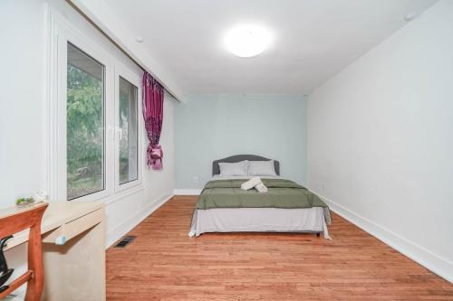 a bedroom with a bed in a white room at Finch Terminal Station 1min -Yonge and Finch Intersection in Toronto