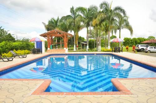 a large swimming pool with a gazebo at Finca Hotel Loma del Café in Pueblorrico