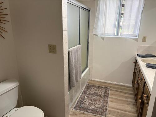 a white bathroom with a toilet and a sink at Wolf Den retreat on 20 acres in Julian