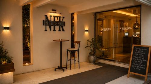 a restaurant with a stool in front of a window at NFK The House Hotel in Antalya