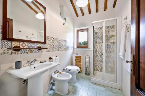 a bathroom with a sink and a toilet and a shower at Il Martellino in Follonica